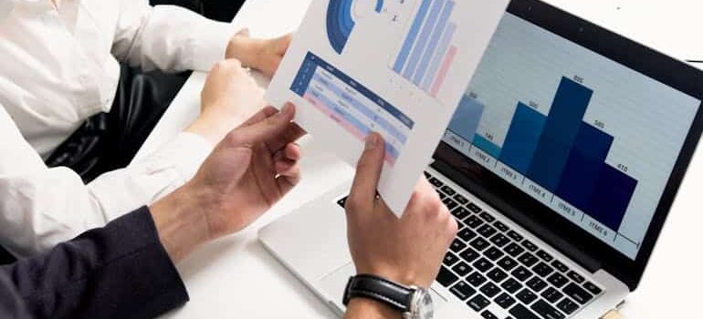 A person reviewing reports and analytics on a laptop, showing what happens to your leads when you stop paying for ads and traffic data changes.