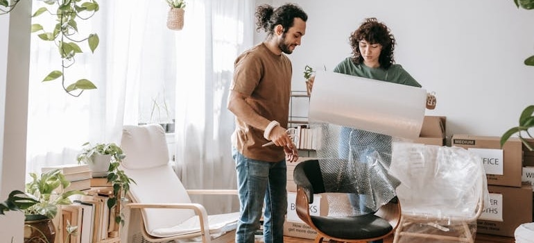 A couple packing their items before moving with a company that uses strategies for utilizing social media for marketing