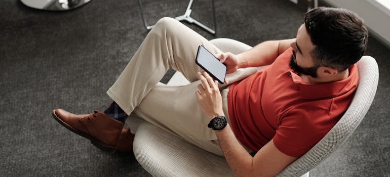 A person using a smaprthone to look for moving companies