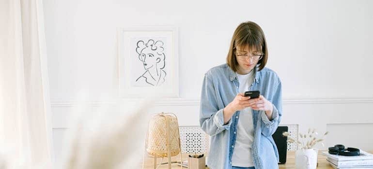 A person using a smartphone to look for moving companies
