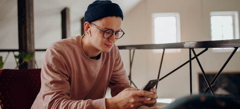 A person using a smartphone to look for moving companies