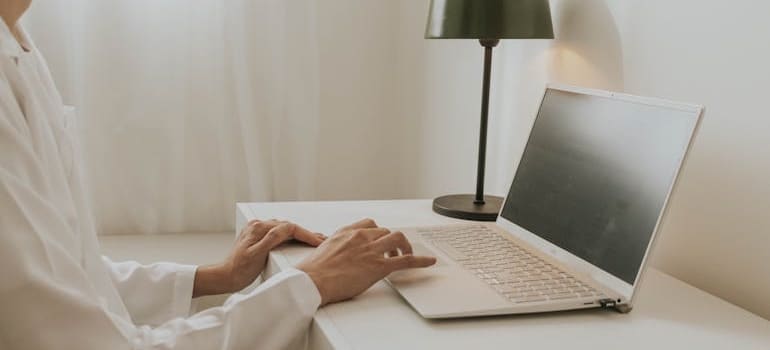 A person using a laptop to do online research on getting Google to index your pages