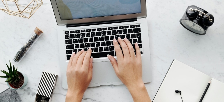 An above shot of a person using a laptop.