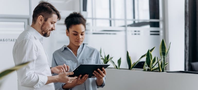 Two people discussing what Google knows about your moving company after an SEO audit