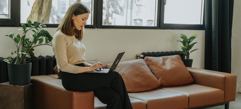 A person using a laptop to book a move with a company that knows that inconsistent business info hurts both SEO and trust