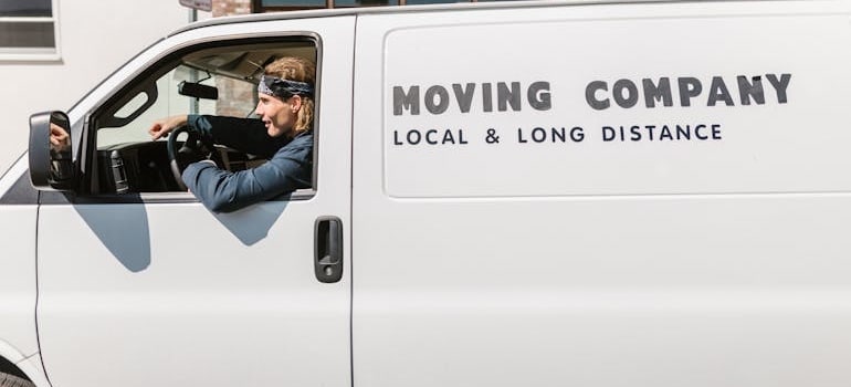 A moving company employee driving a van