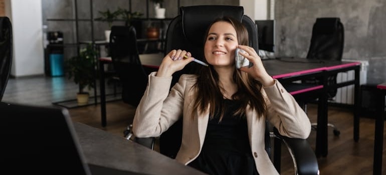 An employee of a moving company answering a phone call after learning that the answer to "Are quote calculators replacing phone calls?" is no