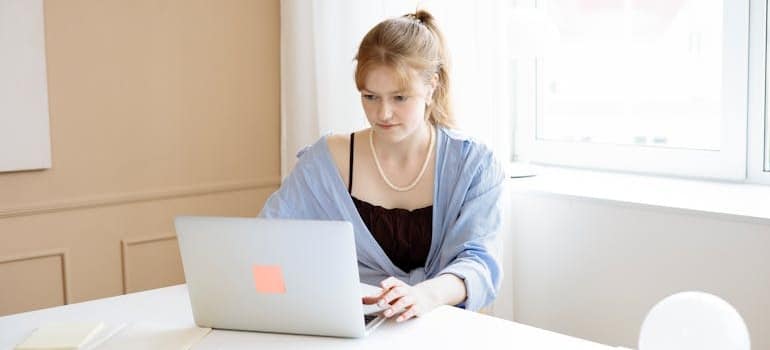 A person using a laptop and exploring the services of a company that is bidding on affordable movers in Google Ads