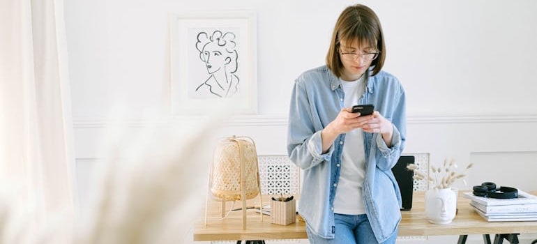 A person holding a smartphone and watching a high-converting moving company ad