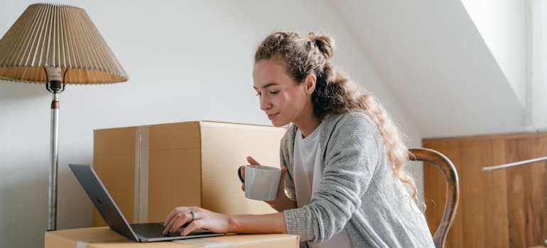 A person using a laptop to look for moving companies