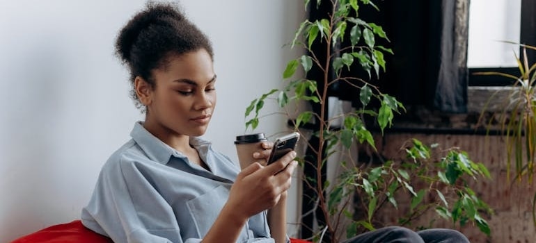 A person using a smartphone to get a moving quote online