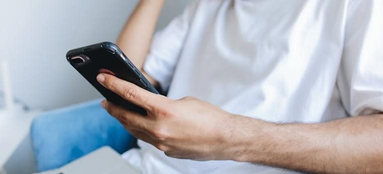 A person using ChatGPT on their smartphone to look for movers
