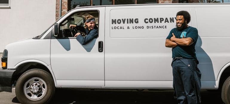Two employees of a moving company and their van