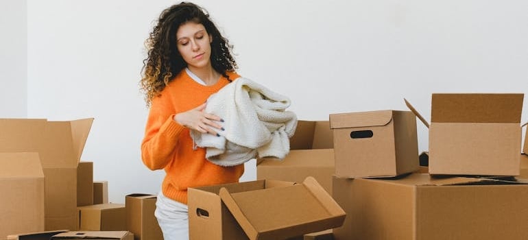 A person packing their items and preparing for a relocation after a call for pricing