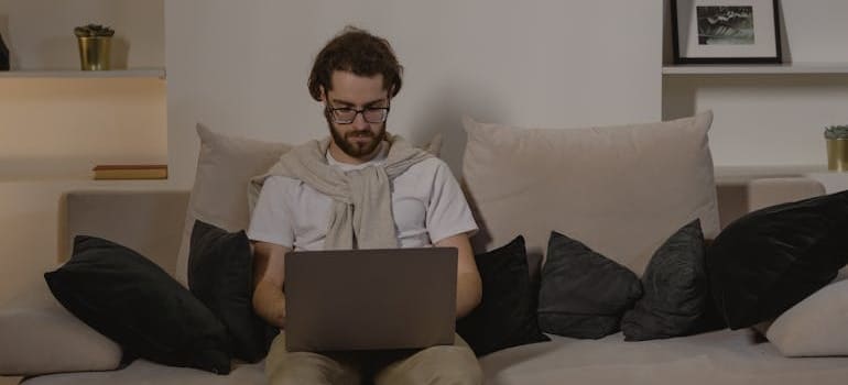 A person using a laptop to look for moving companies