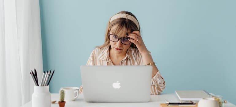 Person using a laptop to research how to spot and dispute fake moving reviews using AI