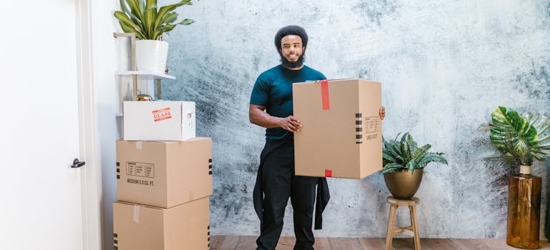 An employee of a moving company holding a box