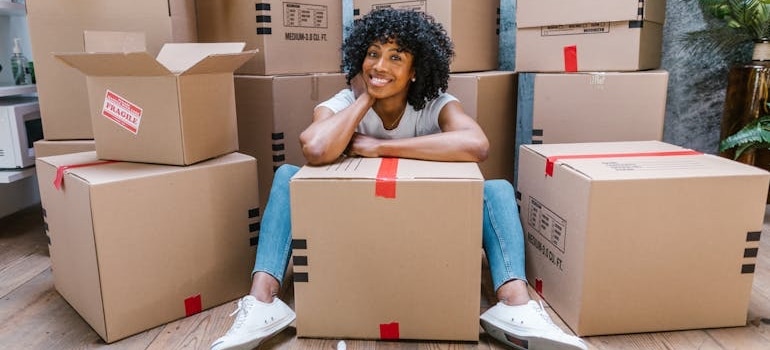A person sitting among boxes during a relocation