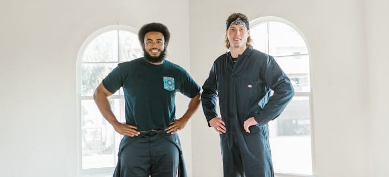 Two employees of a moving company in an empty room