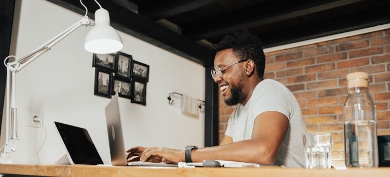 A person using a laptop to leave an online review after a successful move