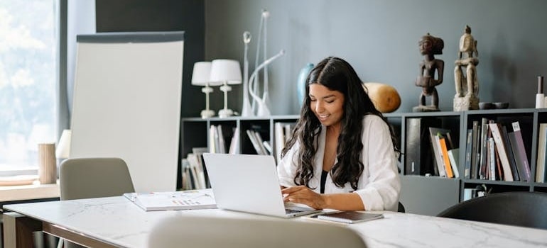A person using a laptop to review search results after learning how Bing AI finds moving companies