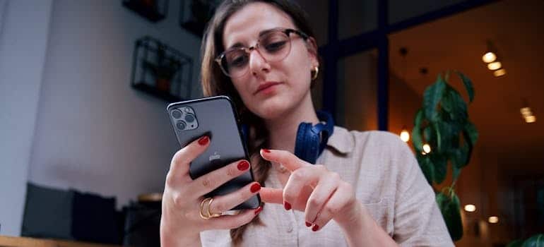 A person using a smartphone searching for movers