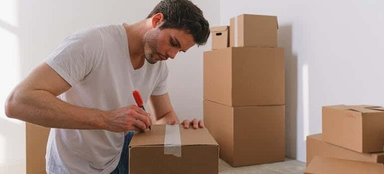 A person packing their items and preparing for a move