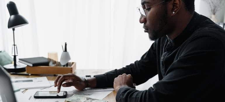 A moving company owner calculating the benefits of AI targeting on Google and Facebook